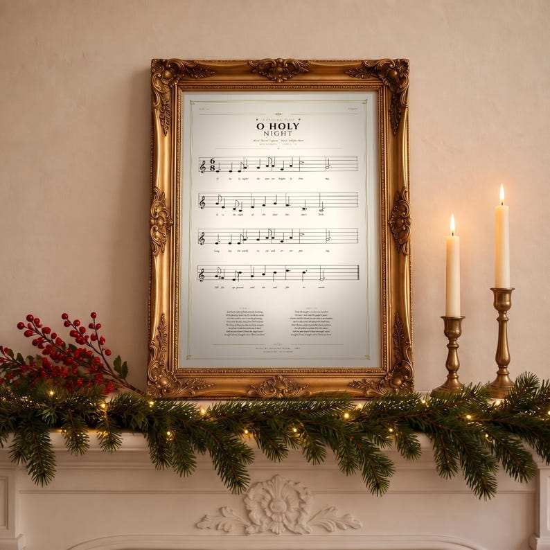 O Holy Night vintage hymn print framed in light oak resting on a wooden console with stacked books, pinecones and dried eucalyptus by a sunlit window, cozy farmhouse living room. Single Christmas sheet music wall art digital download from TheFramedVerse Etsy shop, aged sepia hymnal page style in cream and soft black tones.