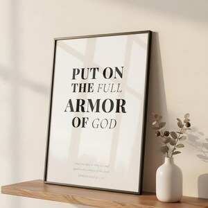 Ephesians 6 Wall Art Put on the Full Armor of God Scripture Print Christian Boys, in contemporary bold serif typography in black on clean white background, hanging above a cozy bed in a peaceful bedroom setting, creating an inspiring and calming atmosphere for morning devotions and evening prayer