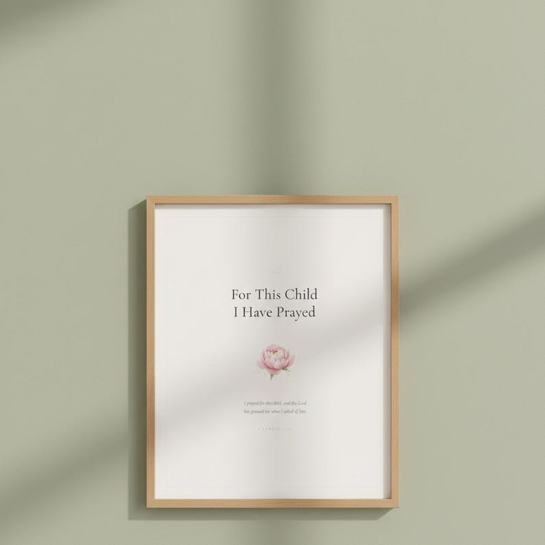 For This Child I Have Prayed 1 Samuel 1 27 Nursery Wall Art Bible Verse Print, in gentle sage green nursery design with soft botanical watercolor illustration, calming earth tones and tender serif typography, styled on a nursery shelf with baby books, a wooden cross and dried flowers, creating a sweet faith-filled vignette that grows with your child