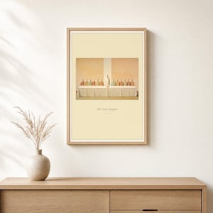 The Last Supper print in its portrait 2:3 version, framed in a slim light oak frame above an oak console with a ceramic vase and dried grass. The modern minimalist Luke 22:19 scene sits in the upper half of a soft cream page with the title and verse reference set beneath it, so the print carries its own mat. Both the wide 3:2 landscape file and this portrait layout are included in the download.