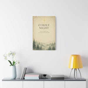 Elegant O Holy Night typography with refined serif lettering on softly aged cream vintage paper. A golden Star of Bethlehem shines above the words while a misty evergreen forest fades along the lower edge. Inspired by the Christmas carol composed by Adolphe Adam in 1847 and Luke 2:11, this warm neutral artwork is printed on stretched canvas. This product view presents the complete design.