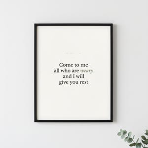 Matthew 11:28 Wall Art Come to Me All Who Are Weary Minimalist Scripture Print B — lifestyle mockup in modern room setting with elegant framed print on wall. This modern minimalist christian scripture wall art print features beautiful serif typography on warm cream background. Matthew 11:28 bible verse digital download printable for home office bedroom living room gallery wall decor. Perfect ch...