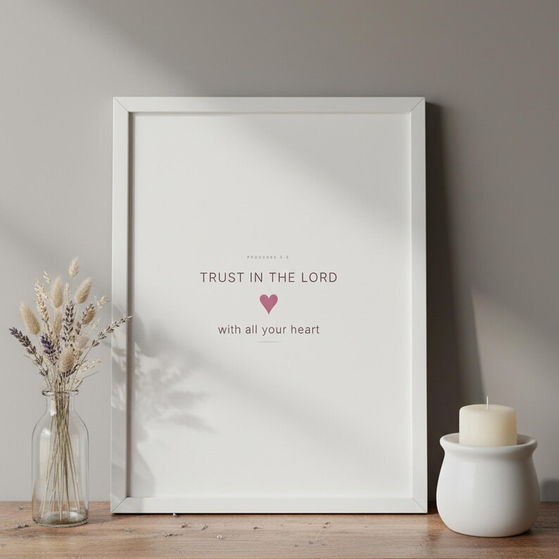 Trust in the Lord With All Your Heart Proverbs 3:5 Wall Art Pink Blush Coquette  — lifestyle mockup in modern room setting with elegant framed print on wall. This coquette bow, pink blush christian scripture wall art print features beautiful serif typography on warm cream background. Proverbs 3:5 bible verse digital download printable for home office bedroom living room gallery wall decor. Perf...