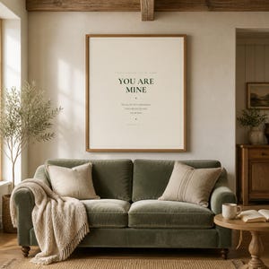 You Are Mine Isaiah 43:1 scripture print minimalist christian baptism gift baby dedication nursery wall art dark forest green typography on warm cream background, above sage grey linen sofa bright airy living room natural window light room lifestyle scene, digital download printable wall art instant download