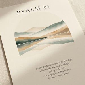 Extreme close-up macro photograph of custom scripture watercolor print on premium archival matte paper, showing crisp Cormorant Garamond serif typography, paper texture, ink saturation, and fine watercolor detail in the arched mountain-lake design, slight 6-degree angle, no props, clean editorial product shot for Christian wall art digital download