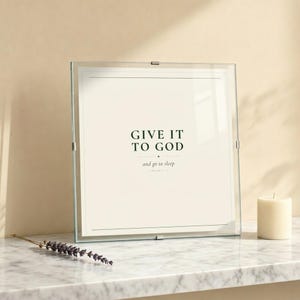 Give It To God in glass frame on marble with lavender and cream candle. Serene editorial styling. Christian bedroom scripture printable by TheFramedVerse.