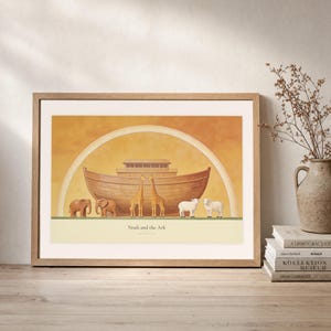 Leaning frame mockup of Noah and the Ark on a rustic wood console beside stacked art books and a tall ceramic vessel with dried stems. The print shows a wooden ark beneath a rainbow with three animal pairs, elephants, giraffes, and sheep. The oak frame, broad cream mat, plaster wall, and soft side light create a relaxed display while keeping the title and Genesis 7:9 legible.