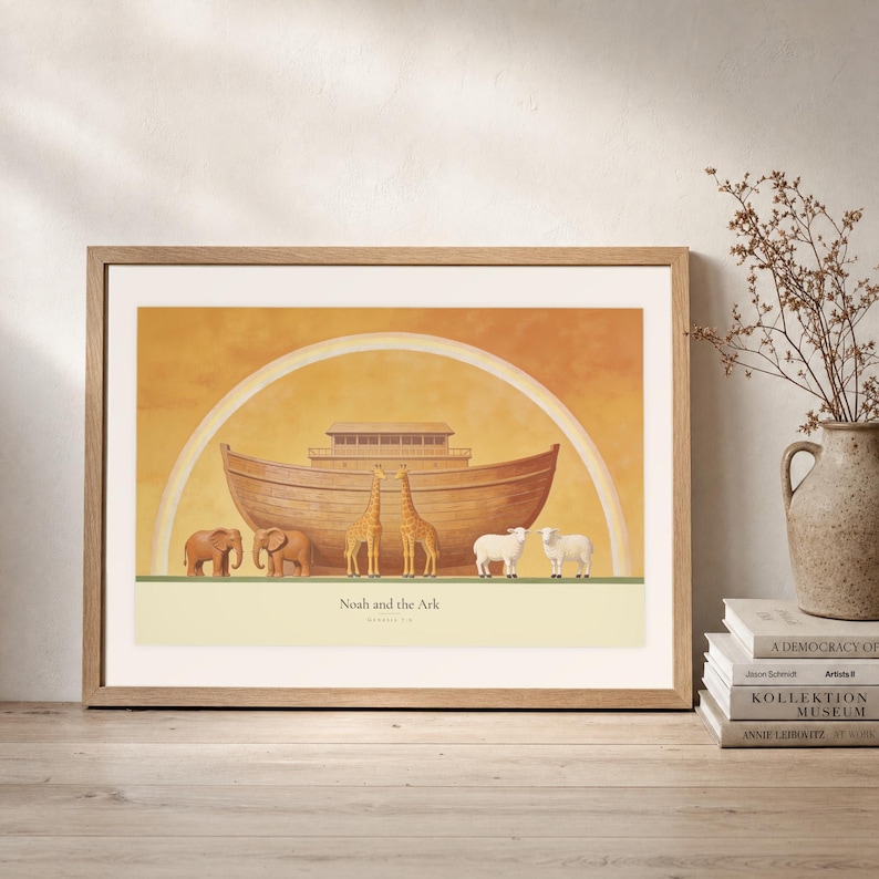 Leaning frame mockup of Noah and the Ark on a rustic wood console beside stacked art books and a tall ceramic vessel with dried stems. The print shows a wooden ark beneath a rainbow with three animal pairs, elephants, giraffes, and sheep. The oak frame, broad cream mat, plaster wall, and soft side light create a relaxed display while keeping the title and Genesis 7:9 legible.