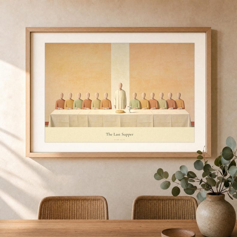 The Last Supper wall art in an oak landscape frame hung above a walnut dining table set with linen napkins, a stoneware bowl and two taper candles, cream plaster wall with an exposed ceiling beam and soft evening window light. Modern Christian dining room decor in terracotta and olive earth tones, printable Luke 22:19 art from TheFramedVerse on Etsy.