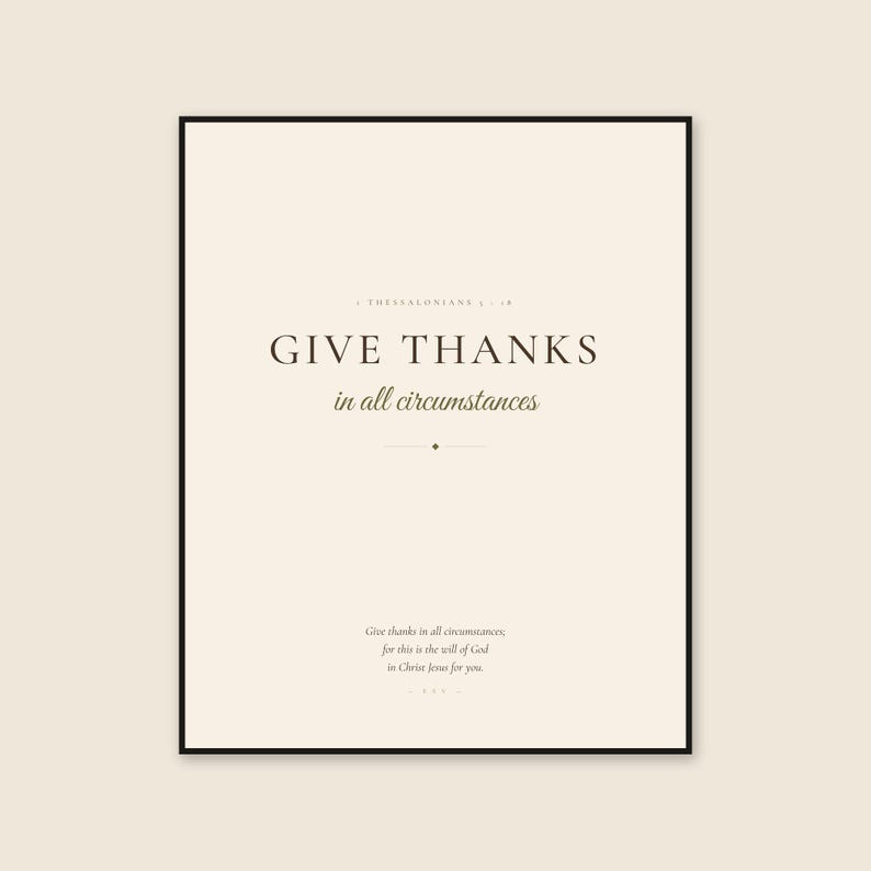 Framed 1 Thessalonians 5:18 Scripture print on a warm cream background, featuring dark brown display serif text reading GIVE THANKS and olive script reading in all circumstances. The calm, earthy design presents a clear message of gratitude and faith for a living room, entryway, bedroom, office, prayer corner, or understated autumn display.