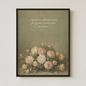 My Grace Is Sufficient 2 Corinthians 12:9 vintage oil painting print in thin black metal frame, shown frontal on off-white textured plaster wall, modern minimalist hanging style, soft single top light source creating gentle shadow below frame, antique floral Christian wall art instant digital download from TheFramedVerse