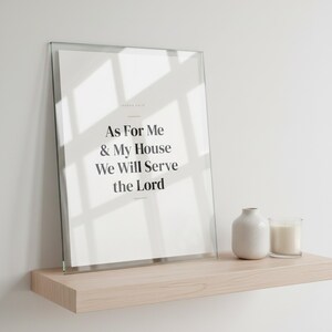 Fathers Day Christian Wall Art Set of 3 Bible Verse Prints Scripture Dad Gift, in warm masculine modern typography with bold serif lettering, a meaningful scripture gift for Christian fathers and husbands, styled on a wooden floating shelf next to a ceramic vase with dried eucalyptus branches and stacked books, creating a warm and inviting Christian home decor vignette