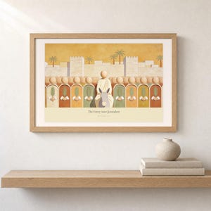 Shelf mockup of The Entry into Jerusalem in a light oak frame resting on a pale wood surface beside stacked neutral books and a rounded ceramic vase. The framed print shows the entry into Jerusalem, with a crowd of faceless figures raising flat palm fronds along the city wall. Cream matting, soft wall texture, and natural light present the horizontal Bible artwork at an easy domestic scale.