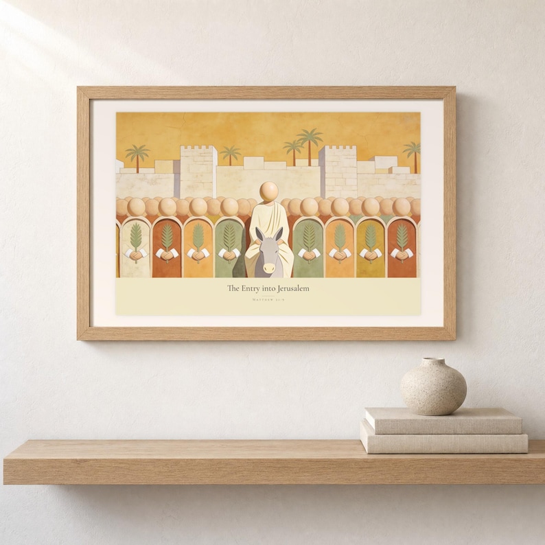 Shelf mockup of The Entry into Jerusalem in a light oak frame resting on a pale wood surface beside stacked neutral books and a rounded ceramic vase. The framed print shows the entry into Jerusalem, with a crowd of faceless figures raising flat palm fronds along the city wall. Cream matting, soft wall texture, and natural light present the horizontal Bible artwork at an easy domestic scale.