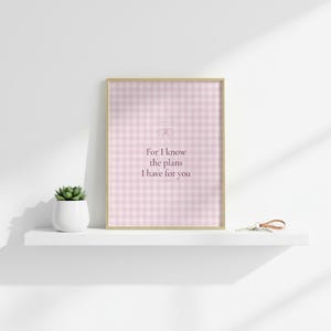For I Know the Plans I Have for You Jeremiah 29:11 Wall Art Pink Blush Coquette  — botanical glass frame mockup with natural light and greenery. This coquette bow, pink blush christian scripture wall art print features beautiful serif typography on warm cream background. Jeremiah 29:11 bible verse digital download printable for home office bedroom living room gallery wall decor. Perfect christi...