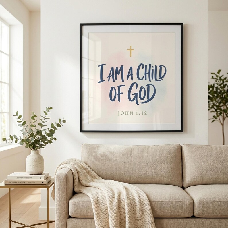 Modern Kids Christian wall art print I Am A Child Of God displayed in premium glass frame above a beige linen sofa in a sunlit family living room with eucalyptus and brass side table. Perfect baptism gift, baby shower gift, christian baby gift, and modern nursery wall art for any room.