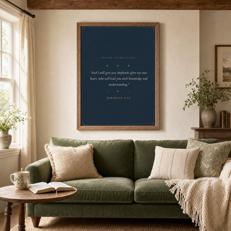 Jeremiah 3:15 Shepherds After My Own Heart print framed in light oak above a cream linen reading chair with knit throw, open leather Bible and ceramic mug on side table, soft warm afternoon window light, minimalist farmhouse christian home decor, pastor appreciation wall art instant digital download from TheFramedVerse Etsy shop