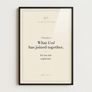 Mark 10:9 'What God Has Joined Together' modern Christian wedding scripture print in thin black metal frame, frontal view on off-white textured wall, modern minimalist styling with soft top light and gentle shadow below frame, e-commerce hero photograph, instant download from TheFramedVerse