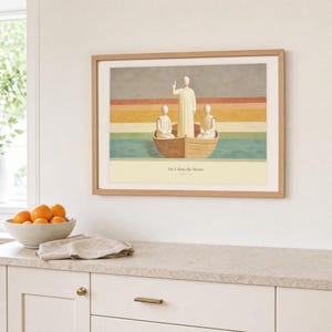 Kitchen mockup of He Calms the Storm framed in light oak above a pale stone counter, white cabinetry, a linen cloth, and a bowl of oranges. The artwork shows Christ standing in a wooden boat with a raised hand above calm layered water. Bright window light and the warm cream mat demonstrate how the Christian print works in a clean, welcoming kitchen interior.