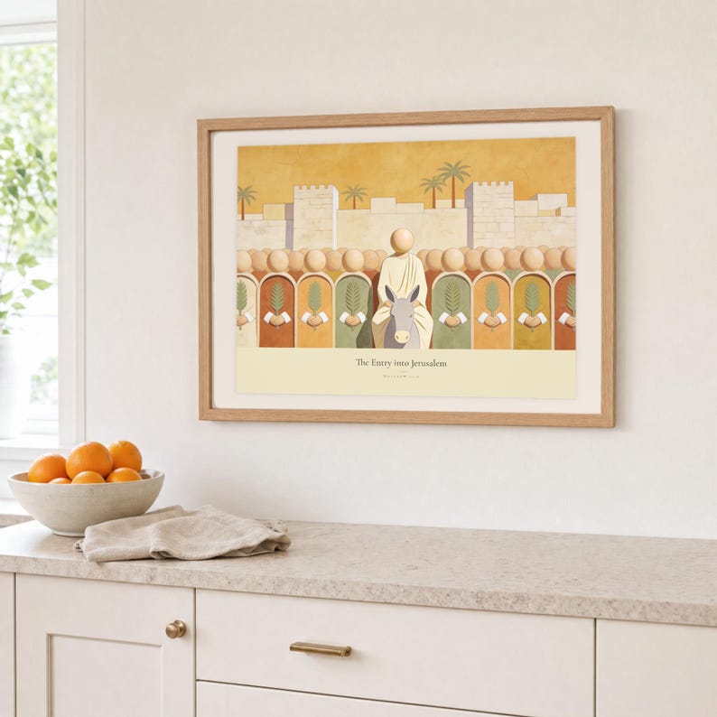 Kitchen mockup of The Entry into Jerusalem framed in light oak above a pale stone counter, white cabinetry, a linen cloth, and a bowl of oranges. The artwork shows the entry into Jerusalem, with a crowd of faceless figures raising flat palm fronds along the city wall. Bright window light and the warm cream mat demonstrate how the Christian print works in a clean, welcoming kitchen interior.