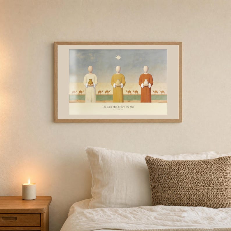 Room mockup of The Wise Men Follow the Star from the Christmas story set, framed in light oak. The artwork shows three travellers carrying vessels beneath the guiding star, with camels receding into the distance across a desert band. The third print of the three piece christian gallery wall.