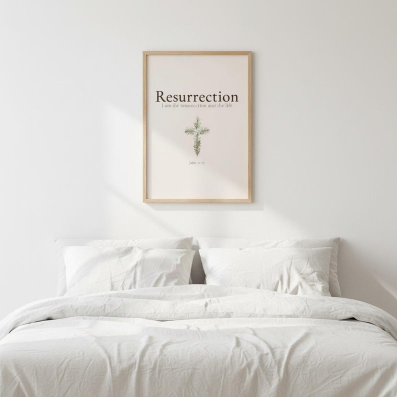 He is Risen Easter Wall Art, Floral Cross Scripture Print, in beautiful floral cross composed of spring roses, greenery and wildflowers, hanging above a cozy bed in a peaceful bedroom setting, creating an inspiring and calming atmosphere for morning devotions and evening prayer. Instant digital download printable wall art in multiple sizes for easy home printing