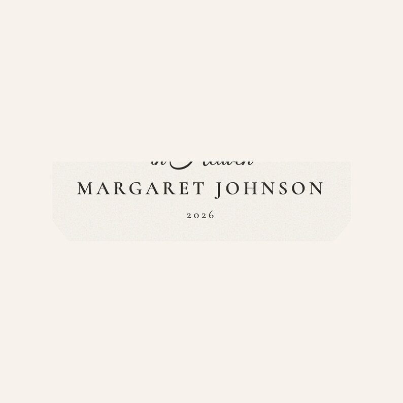 Close up of the personalized name and year zone on the First Christmas in Heaven ornament. The detailed crop highlights MARGARET JOHNSON in spaced serif lettering with 2026 centered below on the softly textured cream design. This view helps buyers see the readable custom details and careful finish of the cardinal memorial keepsake before ordering.