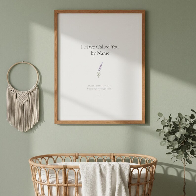 Isaiah 43 1 I Have Called You by Name framed wall art on sage green wall above rattan bassinet with white linens. Macrame decor and eucalyptus. Watercolor lavender sprig illustration. Christian nursery printable digital download for baby shower baptism gift.