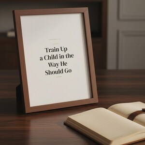 Train Up a Child in the Way He Should Go Proverbs 22:6 Wall Art Christian Father — lifestyle mockup in modern room setting with elegant framed print on wall. This Fathers Day christian scripture wall art print features beautiful serif typography on warm cream background. Proverbs 22:6 bible verse digital download printable for home office bedroom living room gallery wall decor. Perfect christia...