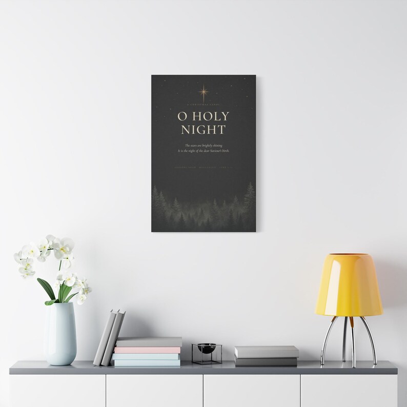 Dark O Holy Night typography combines elegant cream serif lettering, textured charcoal paper, glowing golden stars, and a shadowy evergreen forest border. Inspired by the beloved Christmas carol and Luke 2:11, the dramatic black, cream, and gold artwork is printed on stretched canvas. This straight product presentation clearly shows the full design and canvas proportions.