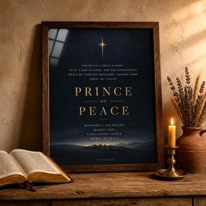 Isaiah 9:6 Prince of Peace on shelf, walnut frame, cozy christmas vignette with candle and pine, dark gold scripture print decor
