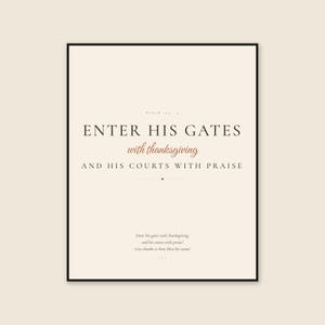 Framed Psalm 100:4 Scripture print on a warm cream background, featuring dark brown display serif text reading ENTER HIS GATES, terracotta script reading with thanksgiving, and a refined praise line below. The neutral autumn palette suits a dining room, entryway, living room, or Thanksgiving gathering while keeping the Bible verse clearly legible.
