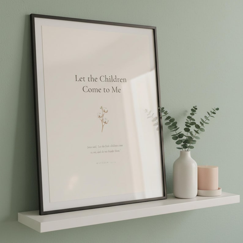 Matthew 19 14 Let the Children Come to Me scripture print in black frame with glass on white shelf against sage green wall. Eucalyptus vase and pink candle. Watercolor cotton flower illustration. Christian nursery Bible verse printable digital download.