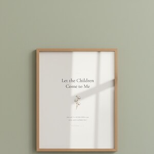 Matthew 19 14 Let the Children Come to Me framed scripture print in oak frame with glass reflection hung on sage green wall. Close-up hero product shot showing watercolor cotton flower illustration and Bible verse. Christian nursery printable digital download for baptism gift.
