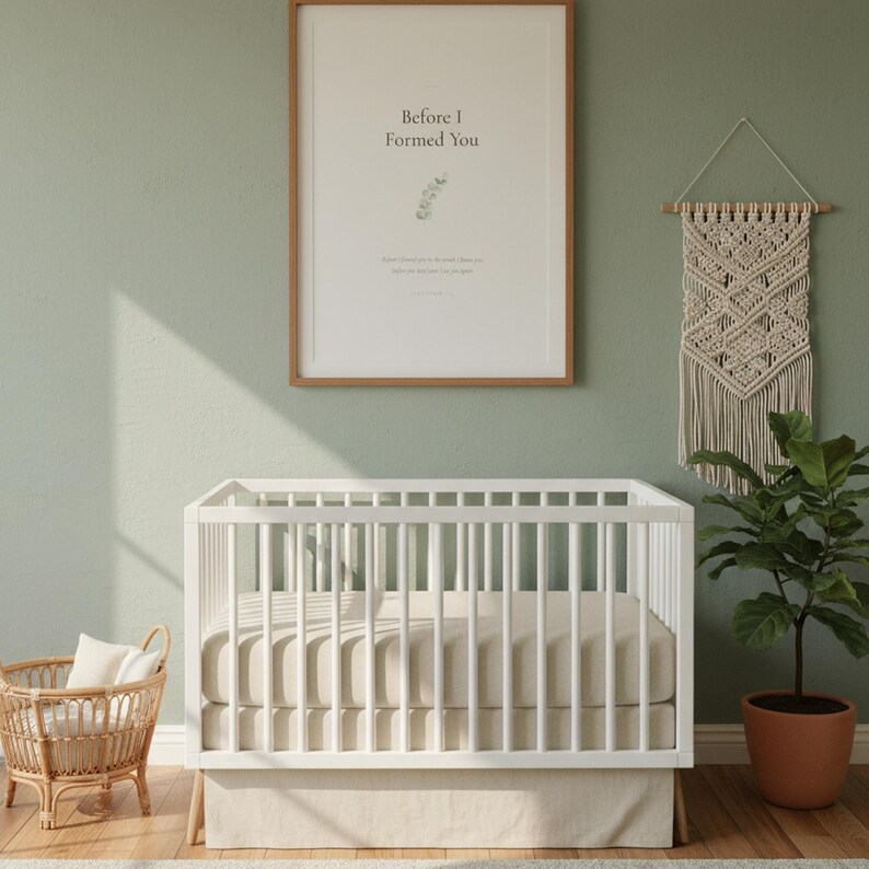 Jeremiah 1 5 Before I Formed You nursery wall art in oak frame on sage green wall above white crib with macrame and rattan decor. Watercolor eucalyptus branch botanical illustration. Gender neutral Christian nursery printable digital download for baptism baby shower christening gift.