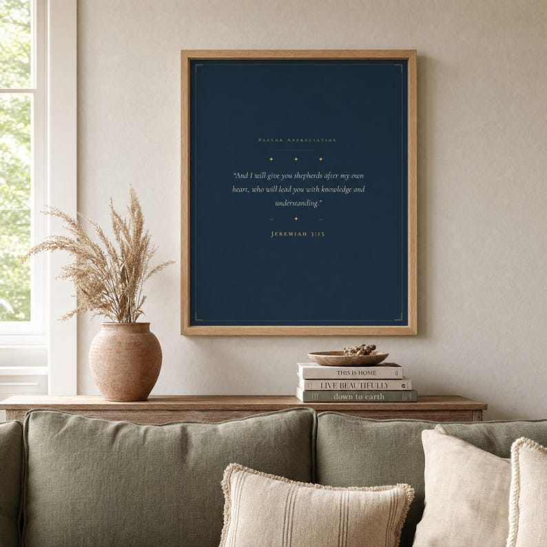 Jeremiah 3:15 Shepherds After My Own Heart modern minimalist scripture print framed in light oak on a sage green linen wall, dried eucalyptus in ceramic vase on console, soft natural daylight, pastor appreciation christian wall art digital download from TheFramedVerse on Etsy, pastoral gifts for church leader