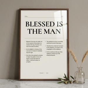 Psalm 1 'Blessed Is The Man' editorial Bible verse art in a slim walnut frame, leaning on white Carrara marble next to a clear glass bud vase with a single olive branch. Premium Pinterest-worthy Christian editorial print, Father's Day digital download from TheFramedVerse on Etsy.