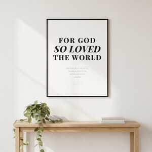 John 3 16 Wall Art For God So Loved the World Scripture Print Modern Christian, in contemporary bold serif typography in black on clean white background, displayed in a bright modern entryway next to a coat rack with natural greenery, serving as welcoming faith-filled home decor. Instant digital download printable wall art in multiple sizes for easy home printing