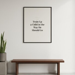 Train Up a Child in the Way He Should Go Proverbs 22:6 Wall Art Christian Father — shelf mockup leaning on wood shelf with decorative items. This Fathers Day christian scripture wall art print features beautiful serif typography on warm cream background. Proverbs 22:6 bible verse digital download printable for home office bedroom living room gallery wall decor. Perfect christian gift idea from ...
