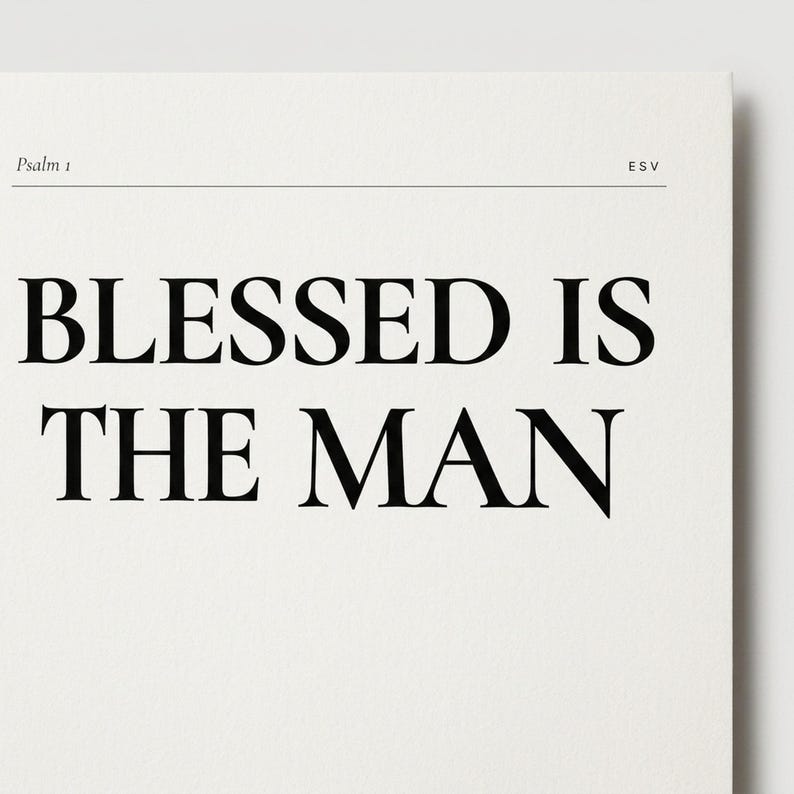 Closeup detail shot of Psalm 1 'Blessed Is The Man' Bible verse wall art print on matte fine-art paper, showing the crisp Cormorant Display all-caps headline, the Psalm 1 ESV tag-line, and the body verse text in 2-column layout. Premium editorial Christian print, Father's Day gift, instant digital download from TheFramedVerse on Etsy.