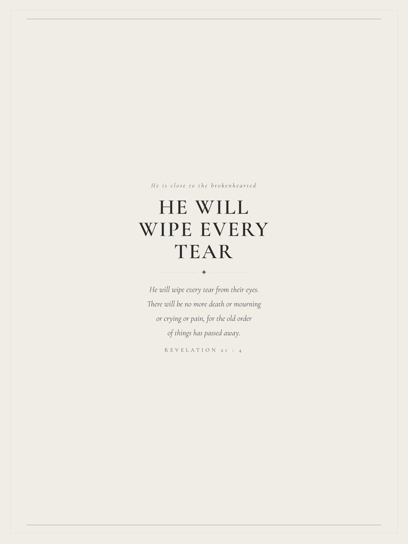 Hero view of the framed design, clearly showing the verse lettering, balanced spacing, and refined color palette. The He Will Wipe Every Tear artwork presents Revelation 21:4 in minimalist black typography on warm beige. This Revelation 21:4 print suits a sympathy gift, memorial space, prayer room, bedroom, or comforting Christian home as printable digital wall art.