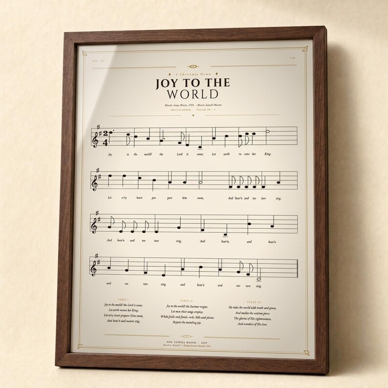 Joy to the World vintage sheet music print in a solid walnut frame, frontal studio shot on a cream backdrop with soft top-left key light and gentle glass reflection. Classical Christmas hymn wall art digital download from TheFramedVerse — single hymnal page reproduction of Psalm 98:4 in warm sepia, cream, and soft black tones.