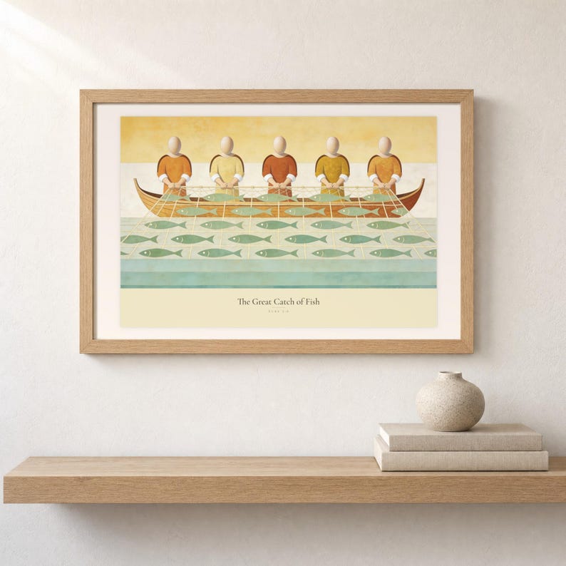 Shelf mockup of The Great Catch of Fish in a light oak frame resting on a pale wood surface beside stacked neutral books and a rounded ceramic vase. The framed print shows faceless fishers lifting a broad net filled with sage fish beside a wooden boat. Cream matting, soft wall texture, and natural light present the horizontal Bible artwork at an easy domestic scale.