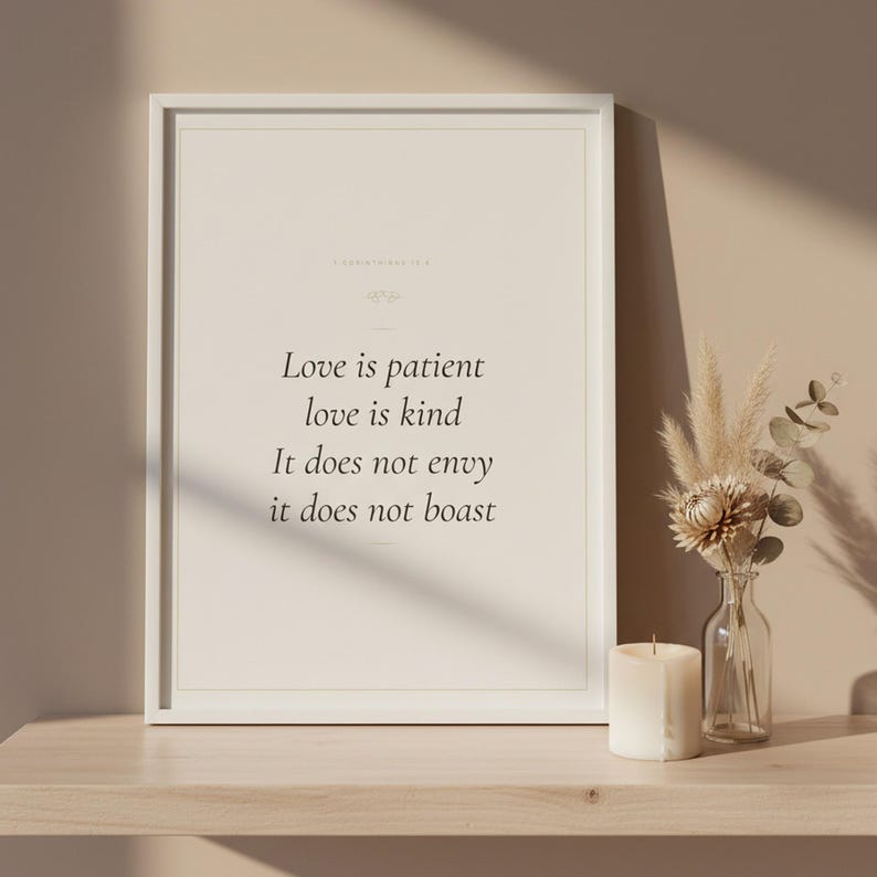 Love Is Patient Love Is Kind 1 Corinthians 13:4 Wall Art Christian Wedding, in romantic wedding typography with elegant calligraphy, delicate gold ornamental accents on warm blush background, hanging above a cozy bed in a peaceful bedroom setting with soft linens and warm lighting, creating an inspiring and calming atmosphere perfect for morning devotions and evening prayer