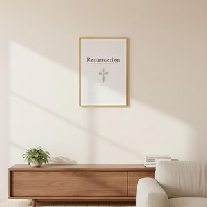 Resurrection Christian Scripture Art, Floral Cross Spring Decor, in beautiful floral cross composed of spring roses, greenery and wildflowers, styled on a wooden floating shelf next to a ceramic vase with dried eucalyptus, creating a warm and inviting Christian home decor vignette