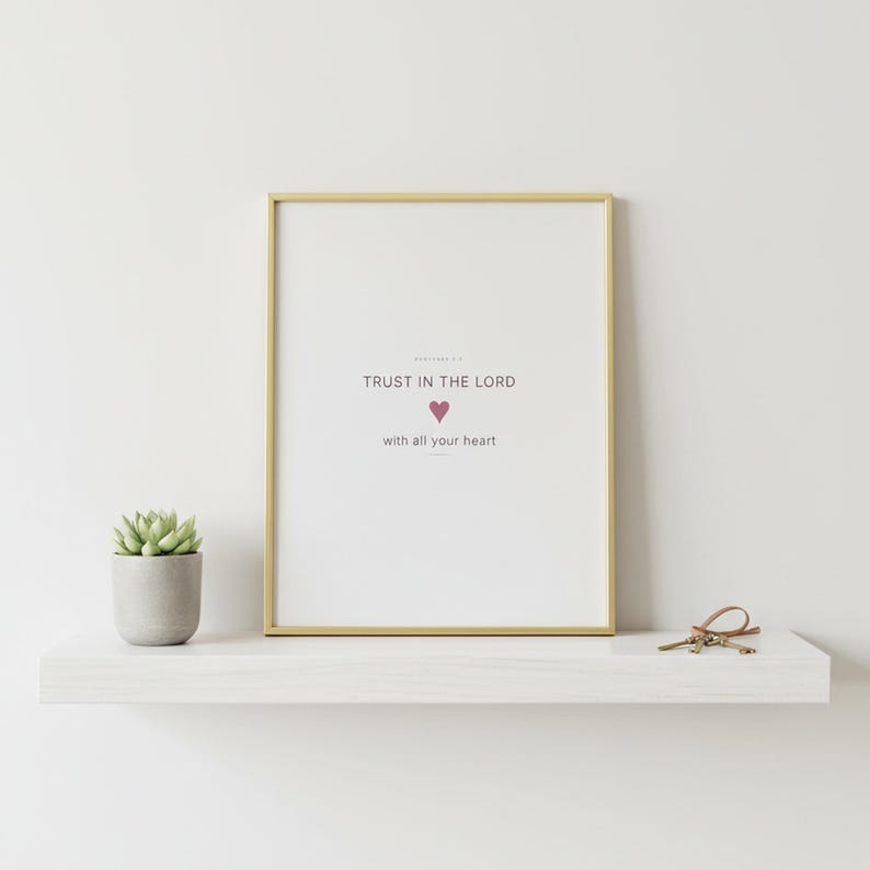 Trust in the Lord With All Your Heart Proverbs 3:5 Wall Art Pink Blush Coquette  — shelf mockup leaning on wood shelf with decorative items. This coquette bow, pink blush christian scripture wall art print features beautiful serif typography on warm cream background. Proverbs 3:5 bible verse digital download printable for home office bedroom living room gallery wall decor. Perfect christian gif...