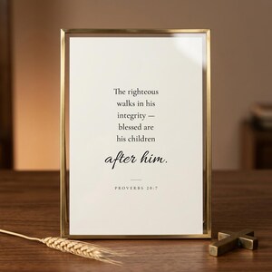 Proverbs 20:7 'The Righteous Walks in Integrity' scripture print in elegant brass-edged glass float frame with glass reflections, beside a dried wheat stem and brass cross on warm walnut. Editorial Father's Day Christian wall art gift, Christian dad and grandfather present, pastor appreciation, instant download.