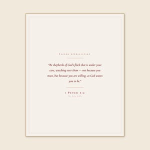 1 Peter 5:2 Be Shepherds of God's Flock print framed in light oak above a sage velvet armchair with cream linen throw, open Bible on oak side table, soft warm afternoon window light, minimalist farmhouse christian home decor, pastor appreciation wall art instant digital download from TheFramedVerse Etsy shop