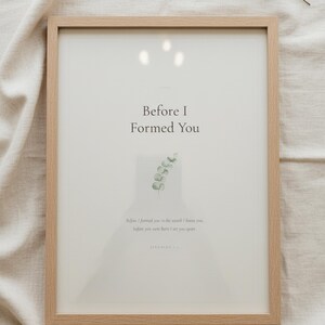 Nursery Bible Verse Wall Art Set of 6 Printable Christian Scripture Prints, in gentle sage green nursery design with soft botanical watercolor illustration and calming earth tones, styled on a wooden floating shelf next to a ceramic vase with dried eucalyptus, creating a warm and inviting Christian home decor vignette