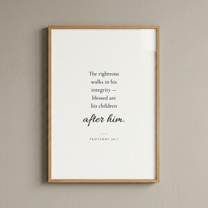 Studio front shot of Proverbs 20:7 'The Righteous Walks in Integrity' scripture print in slim warm oak wood frame on warm greige wall. Clean editorial product photography — Father's Day Christian wall art, Christian dad and grandfather gift, pastor and men's ministry print, instant digital download.